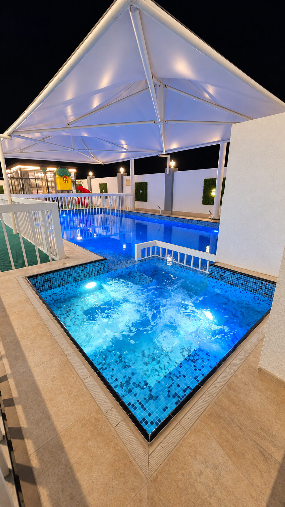 The private pool illuminated at night at Smart Chalet